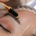 beautician-doing-microblading-procedure-client-s-eyebrows