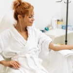 portrait-mindful-woman-sitting-armchair-closed-eyes-while-receiving-iv-infusion-with-vitamins-cosmetology-medicine-concept